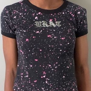A Rue21 black shirt with pink and white color splattered on it, Bratz in silver.